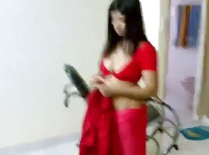 My agreeable Indian stunner displays off her curvaceous figure wearing inviting crimson sundress