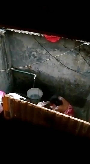 <em>Indian housewife</em> bathing